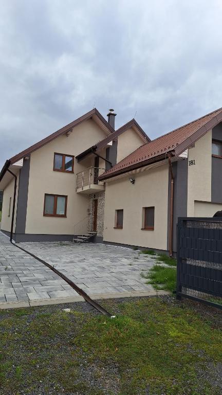 a house with a large driveway in front of it at Penzion Mivex in Kráľová Lehota