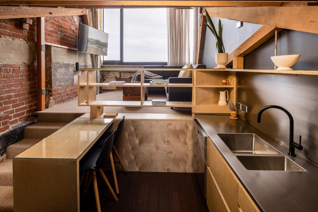 a kitchen with a sink and a counter top at The Thomas Gregg Apartments in Dunedin