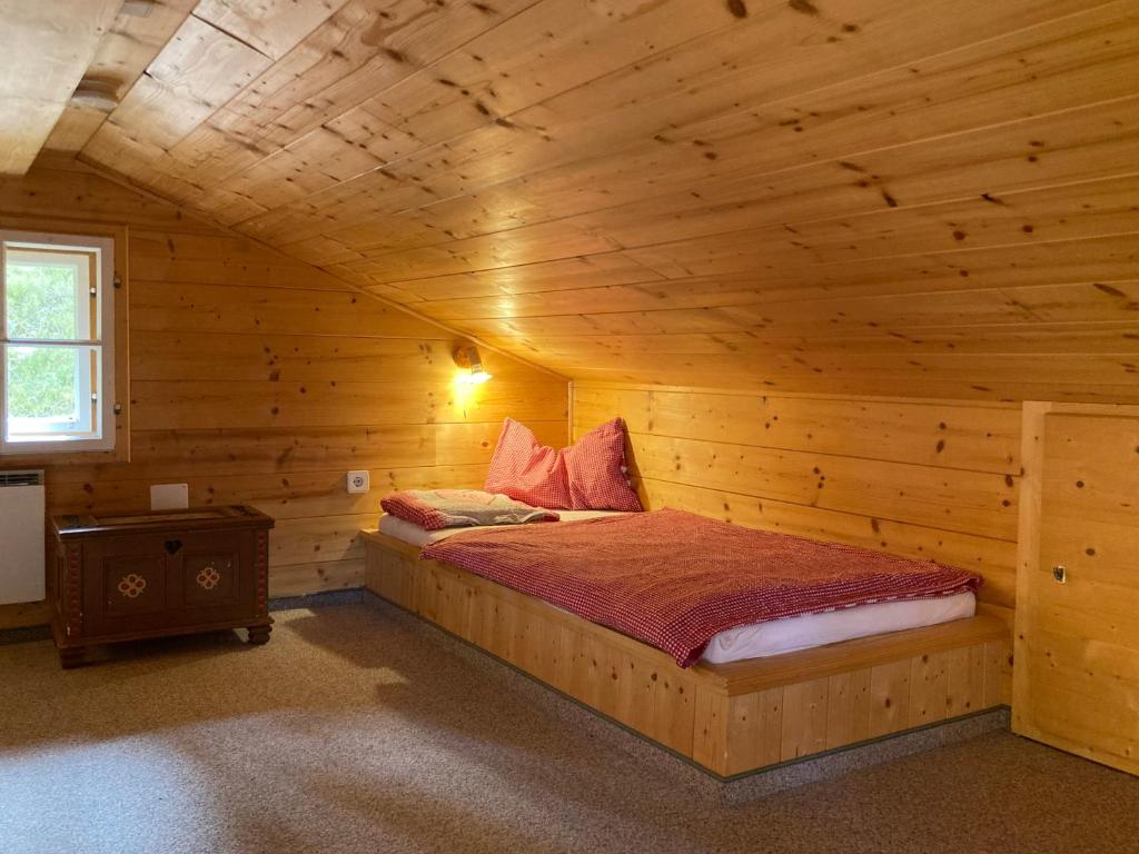 a bedroom with a bed in a wooden cabin at Ski in - Ski out am Hauser Kaibling in Haus im Ennstal