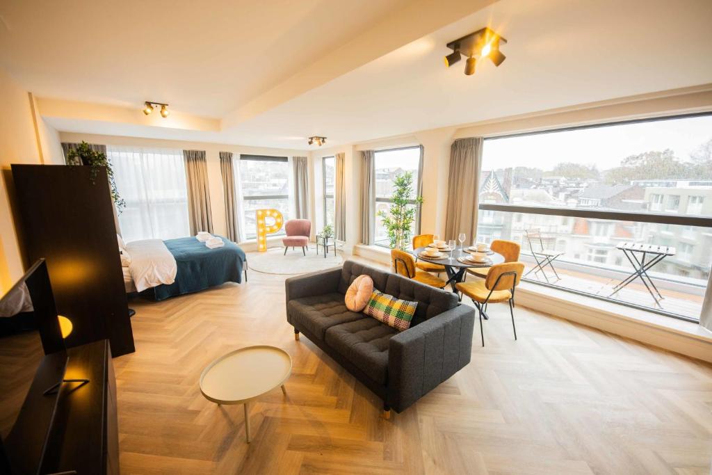 a living room with a couch and a bed at Alphabet Studio Apartments including City view in Hilversum