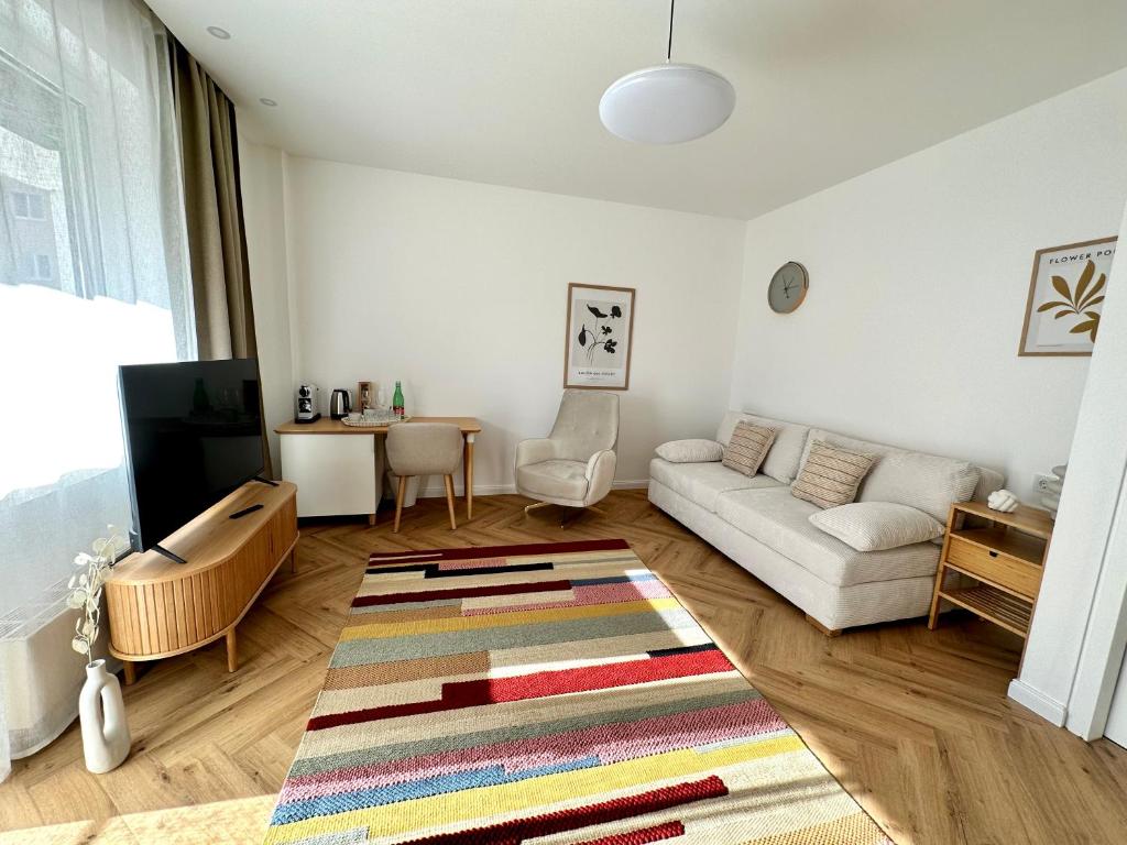 a living room with a couch and a rug at MIRABELLE Homes in Salzburg