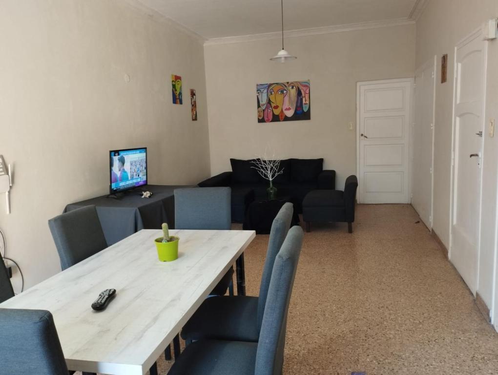 sala de estar con mesa de madera y sillas azules en HOSTAL HOUSE REYMON,habitaciones privadas" precio por persona" en Mendoza