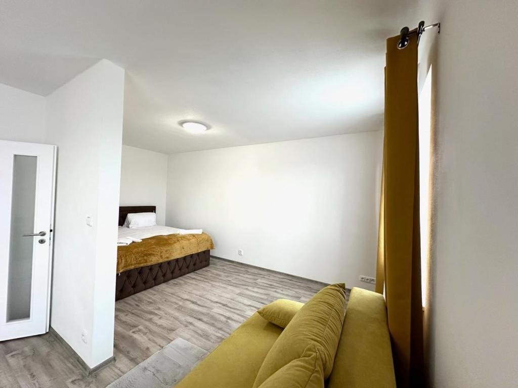 a living room with a couch and a bed at Sky Apartments 511 in Plzeň