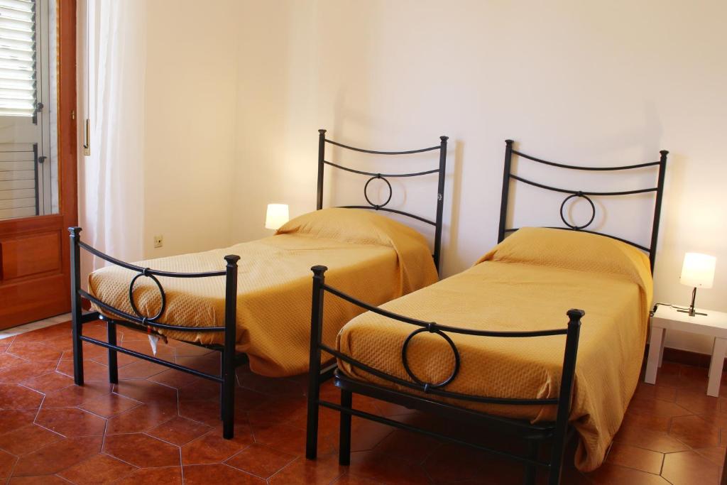 dwa łóżka siedzące obok siebie w pokoju w obiekcie Camera a Grammichele w mieście Grammichele