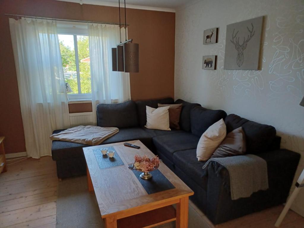 a living room with a blue couch and a table at Turmvilla Mörlunda in Mörlunda