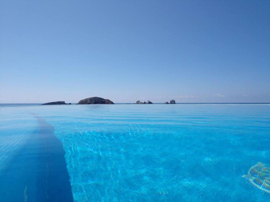 a large body of blue water with islands in the distance at PLAYA PRIVADA del desarrollo in Ixtapa