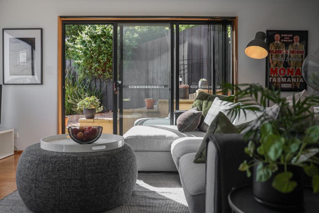 a living room with a couch and a table at Finnview House in Hobart