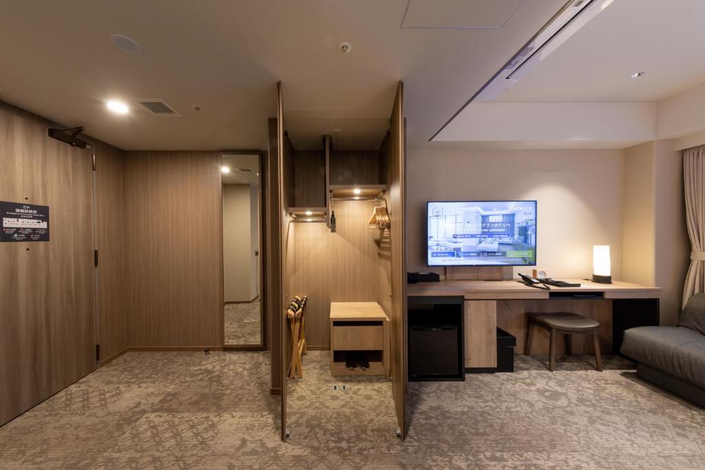 a hotel room with a desk and a television at Iroha Grand Hotel Kintetsu Nara Ekimae in Nara
