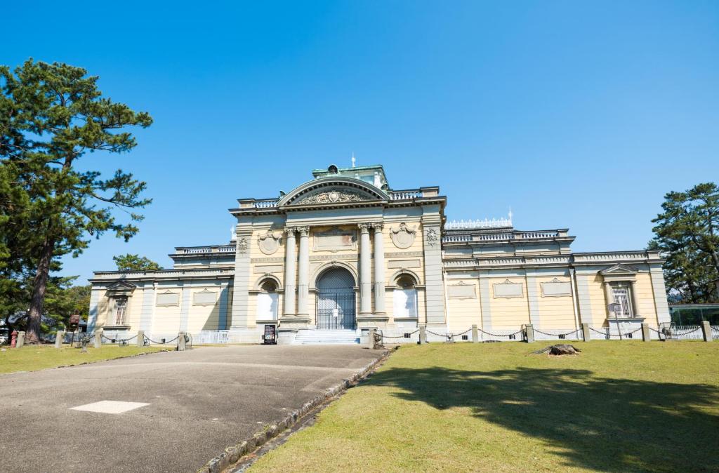 a large white building with a road in front of it at Iroha Grand Hotel Kintetsu Nara Ekimae in Nara