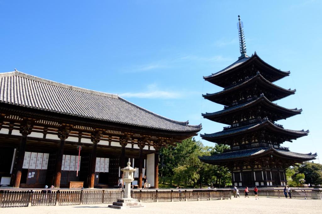 a large building with a pagoda in front of it at Iroha Grand Hotel Kintetsu Nara Ekimae in Nara