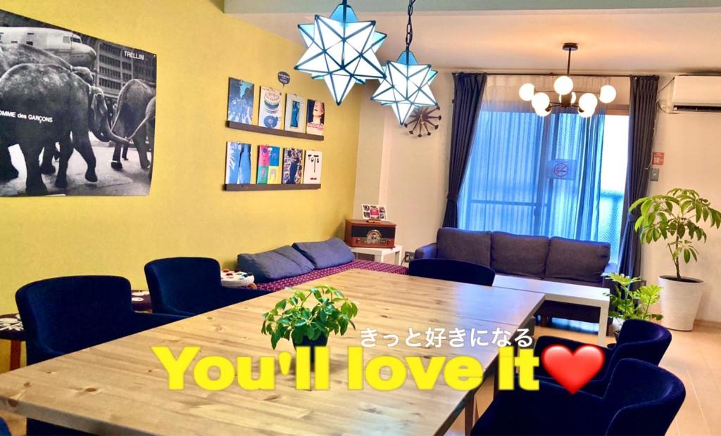 a living room with a dining room table and a living room at Minamide Building 2-4F / Vacation STAY 6127 in Osaka