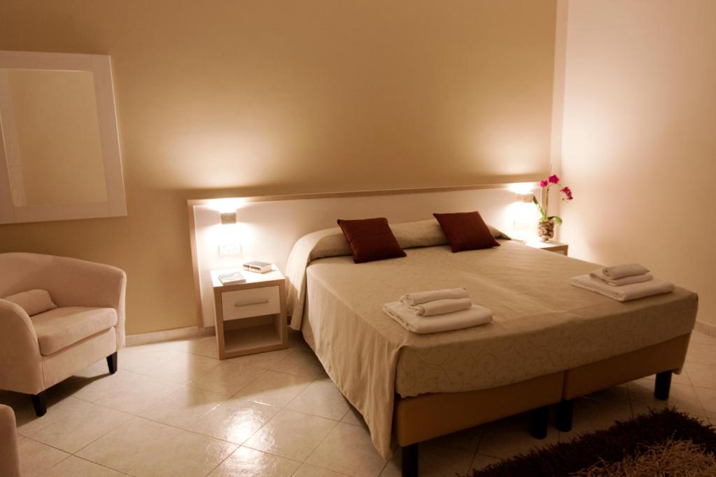 a bedroom with a bed with two towels on it at Hotel Residence Nemo in Brindisi