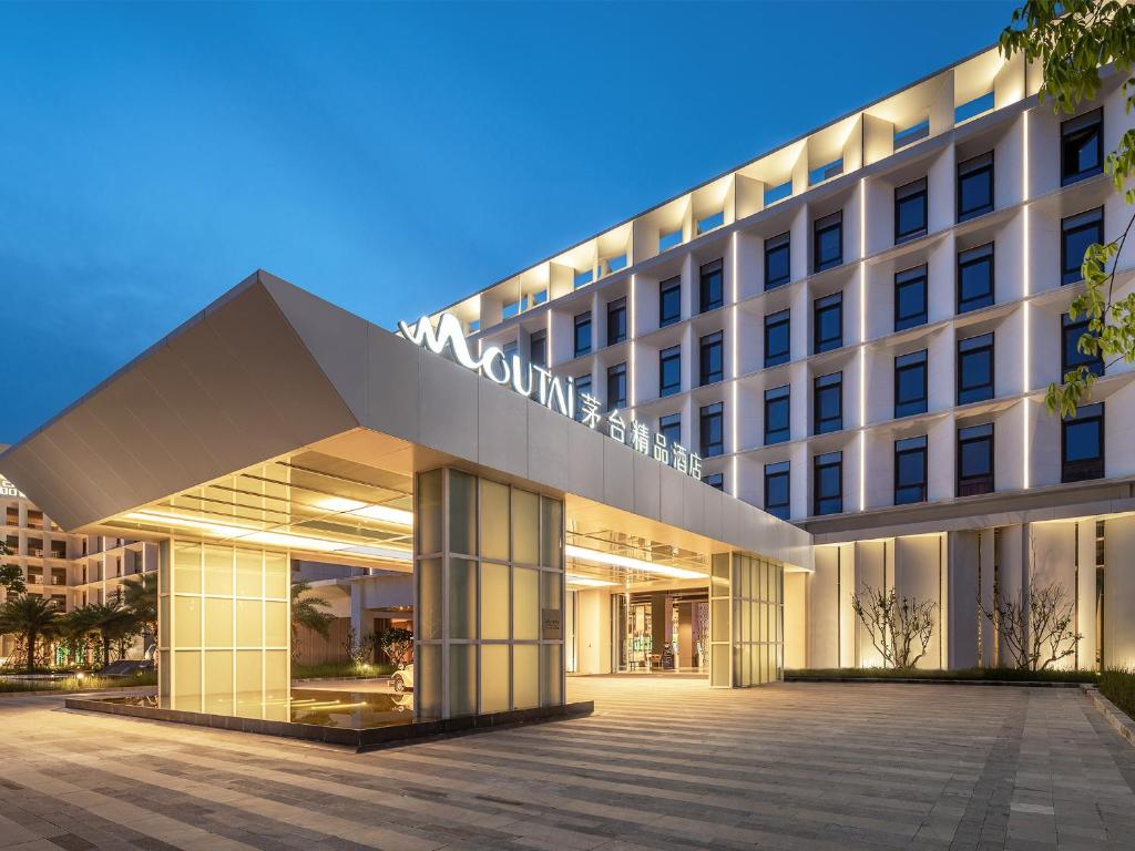 a building with a sign on the front of it at Sanya Haitang Bay Moutai Resort Boutique Hotel in Sanya