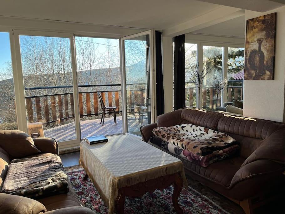 a living room with a couch and a coffee table at Winterheim Sonnenberg in Tetovo