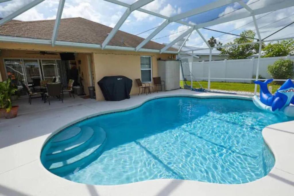 a swimming pool with a pergola and a house at Luxurious Pool Cottage Sleep 2 in Carlton