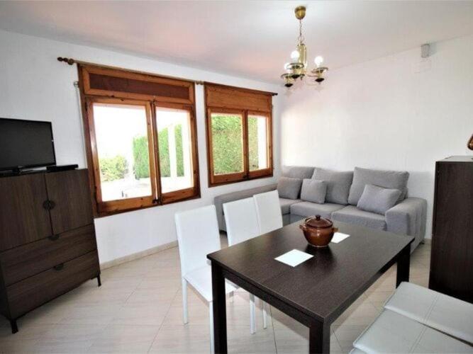 a living room with a table and a couch at Apartments La Pineda, Playa de Pals in Begur