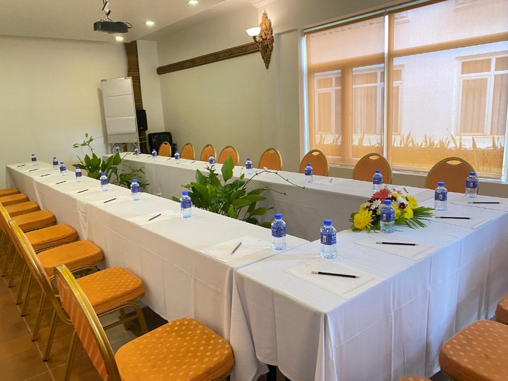 a long table in a room with chairs at Sala Siem Reap Hotel in Siem Reap
