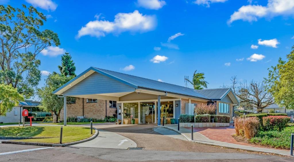 a building with a blue roof at Hunter Oasis in Morpeth