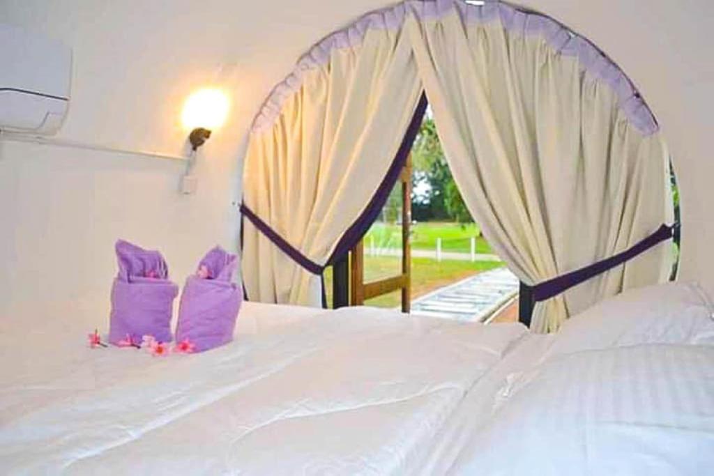 Postel nebo postele na pokoji v ubytování Bagan Pinang Guest House
