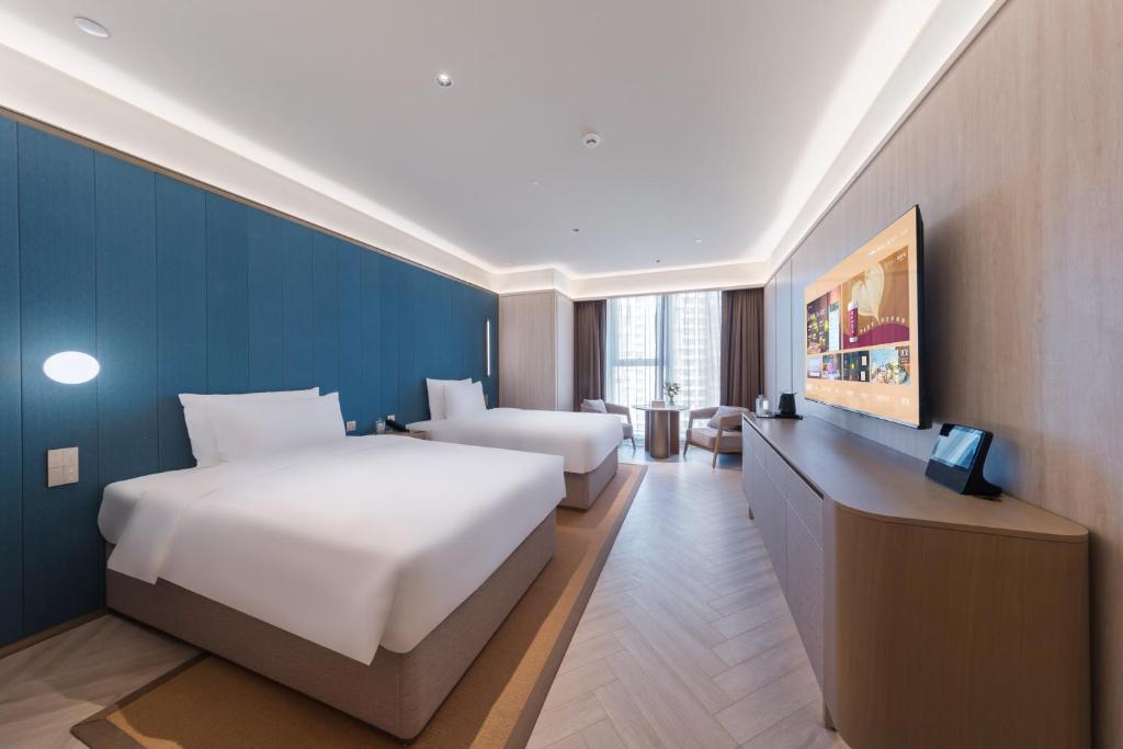 Postel nebo postele na pokoji v ubytování Crystal Orange Hotel - Shenzhen Nanshan Xinhaofang Branch