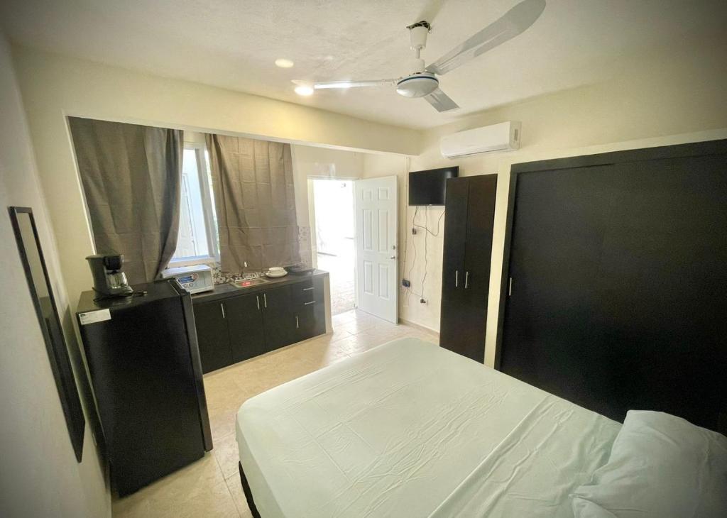 a bedroom with a bed with a black headboard at Casa Creunza de Mar in Playa del Carmen