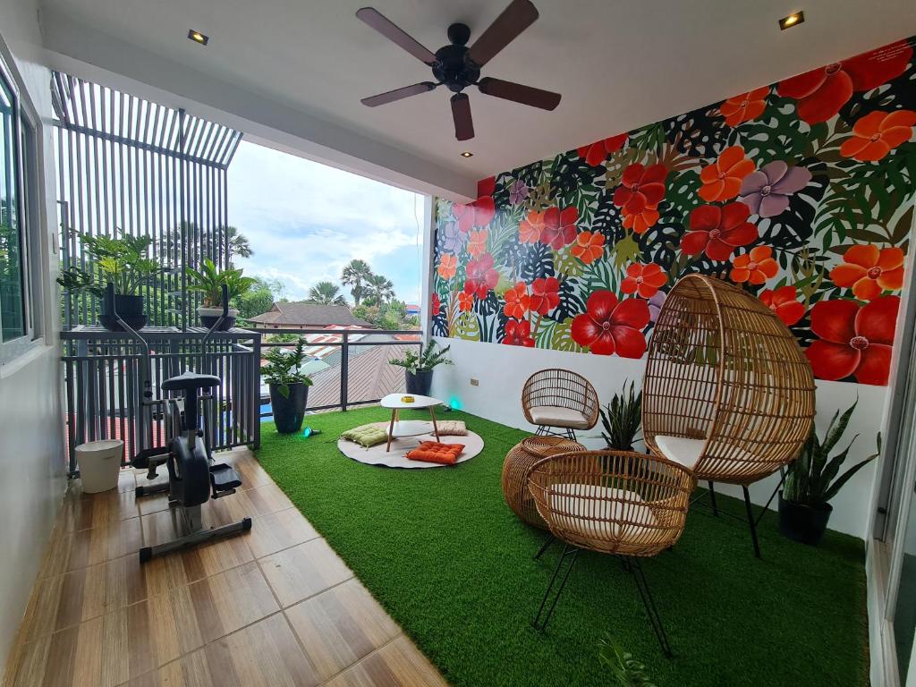 a living room with chairs and a painting on the wall at Hotel Pressie by SMS Hospitality in Panglao