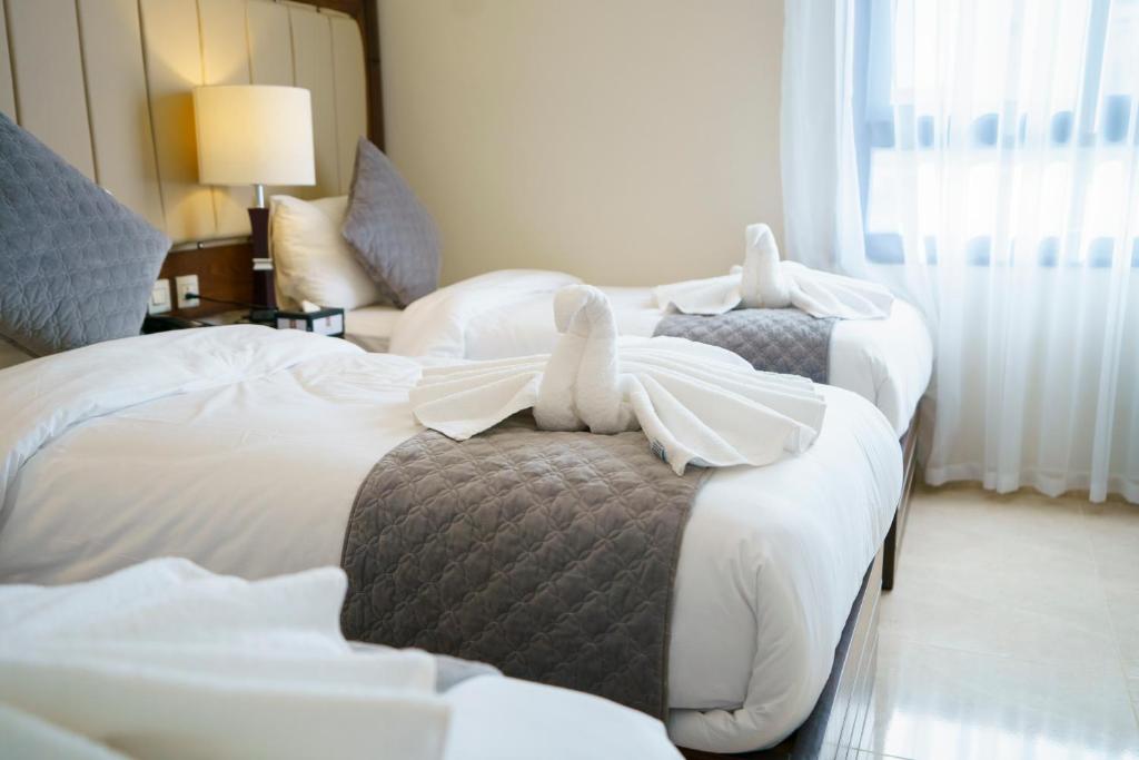 Postel nebo postele na pokoji v ubytování Petra Icon Hotel