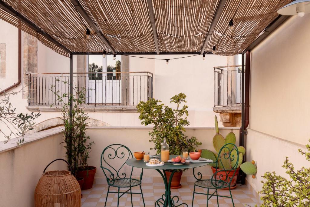 patio ze stołem i krzesłami w obiekcie Balate Dimora in Centro w mieście Ragusa