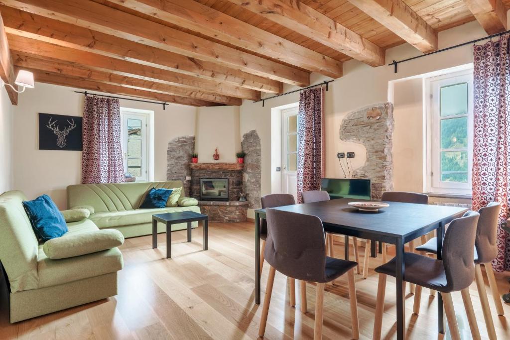 a living room with a table and chairs at Residence V in Ponte di Legno