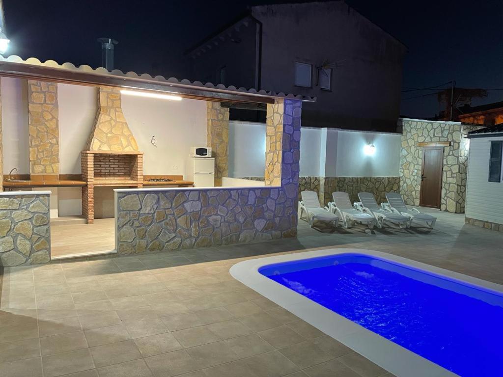 a villa with a swimming pool at night at Las Tres A in Segura de la Sierra