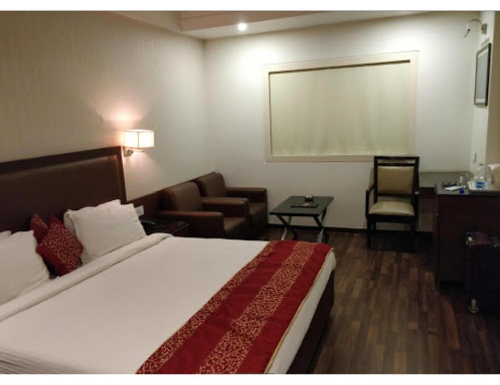 a hotel room with a bed and a chalkboard on the wall at Hotel City Inn, Kakinada, Andhra Pradesh in Kākināda