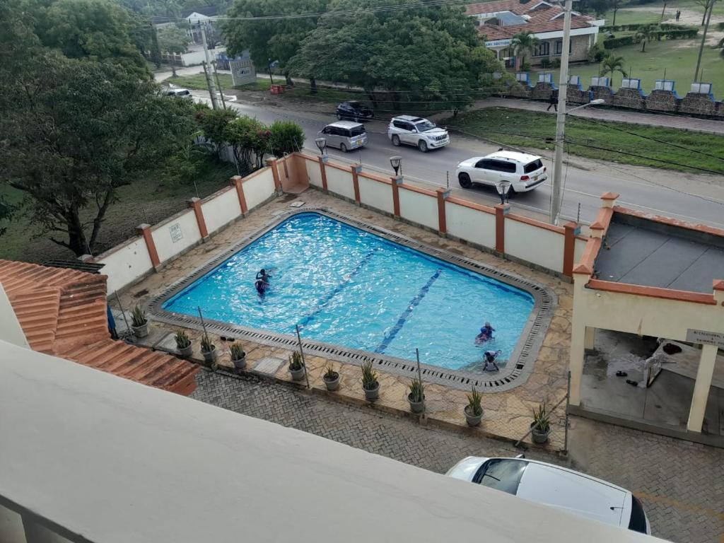 an overhead view of a large swimming pool on a building at Ocean one apartment in Mombasa