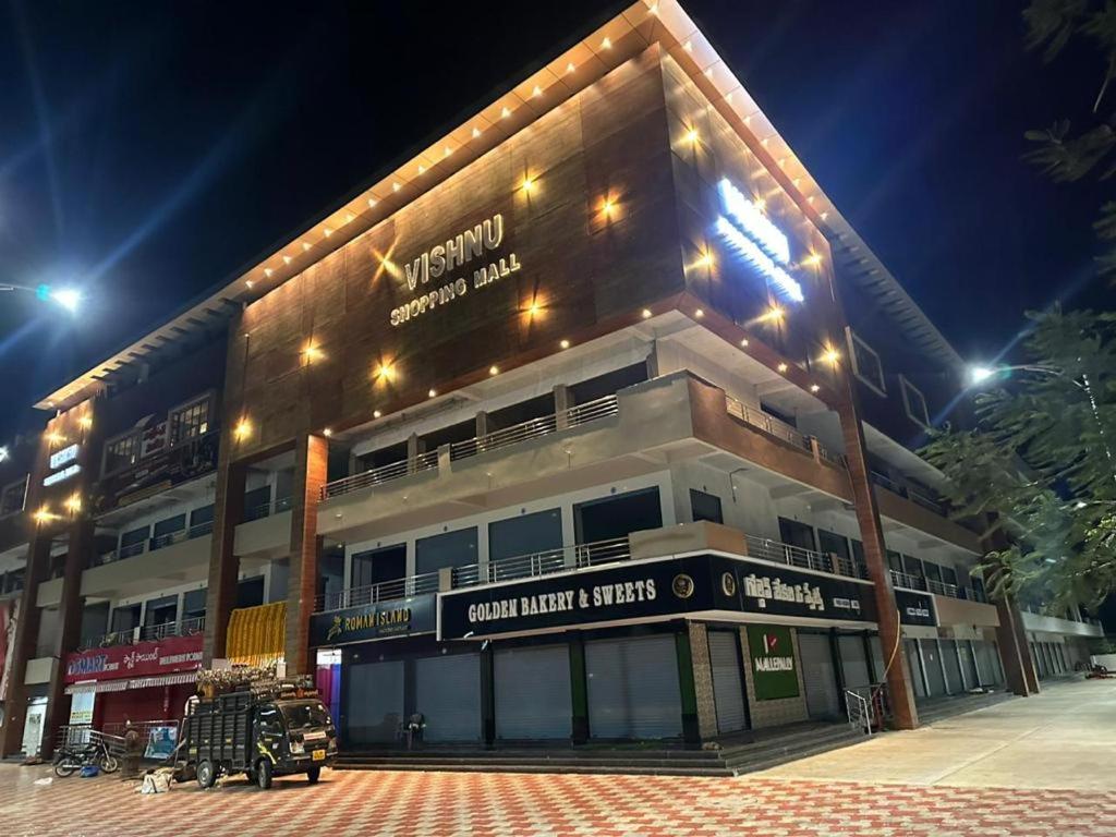 a large building with a street at night at SWAGATH RESIDENCY in Devarkonda