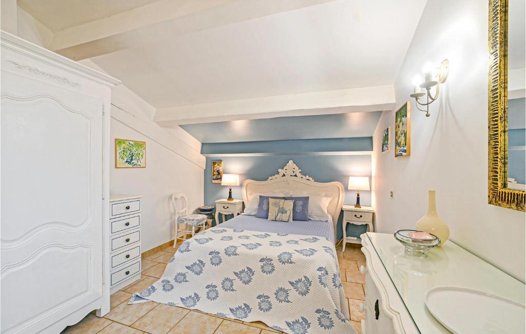 a bedroom with a king sized bed and a sink at Awesome Home In Fontarches With 2 Bedrooms, Wifi And Outdoor Swimming Pool in Fontarèches