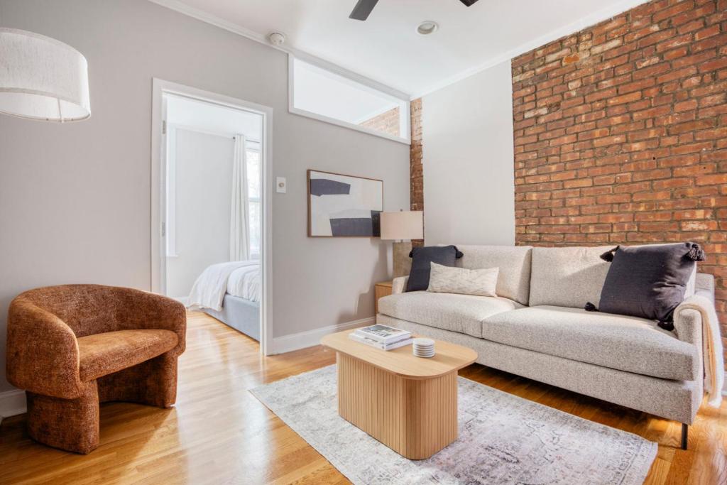 a living room with a couch and a chair at West Village 1br w wd nr park NYC-1275 in New York