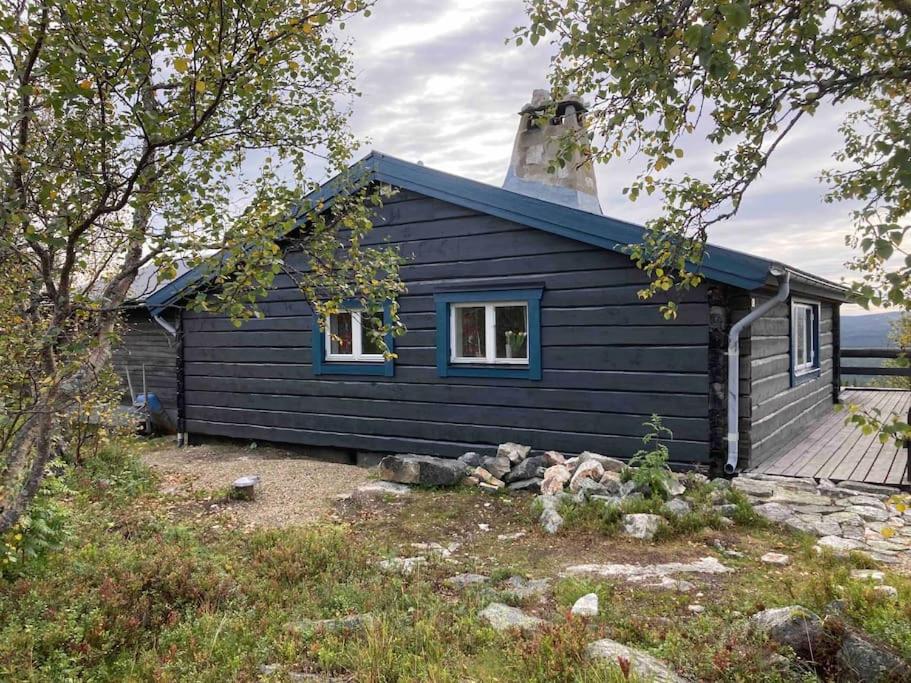 a blue house with a tower on top of it at Fantastiskt 10+2bädds stuga i Klövsjö in Klövsjö