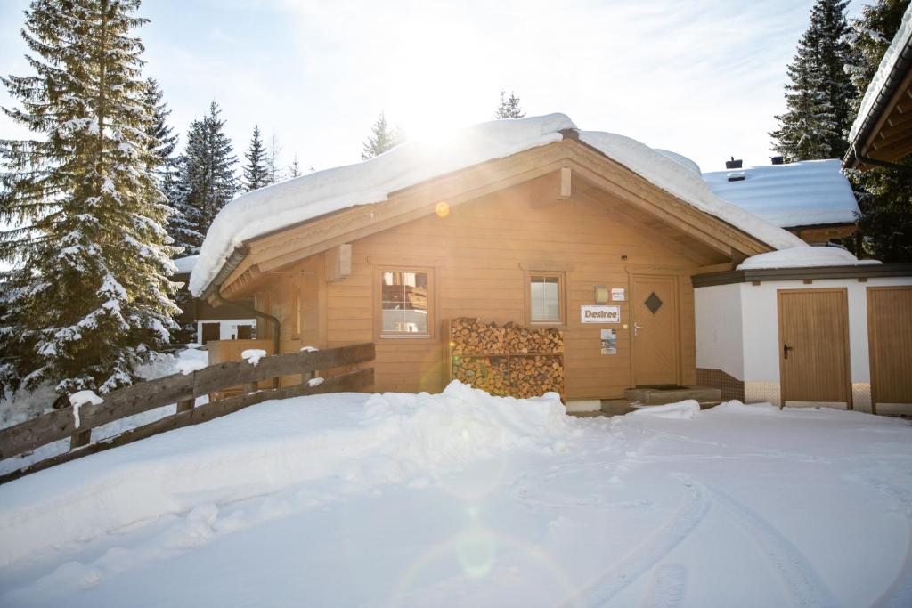 a house with a pile of snow in front of it at Chalet Hochkrimml 141 in Krimml