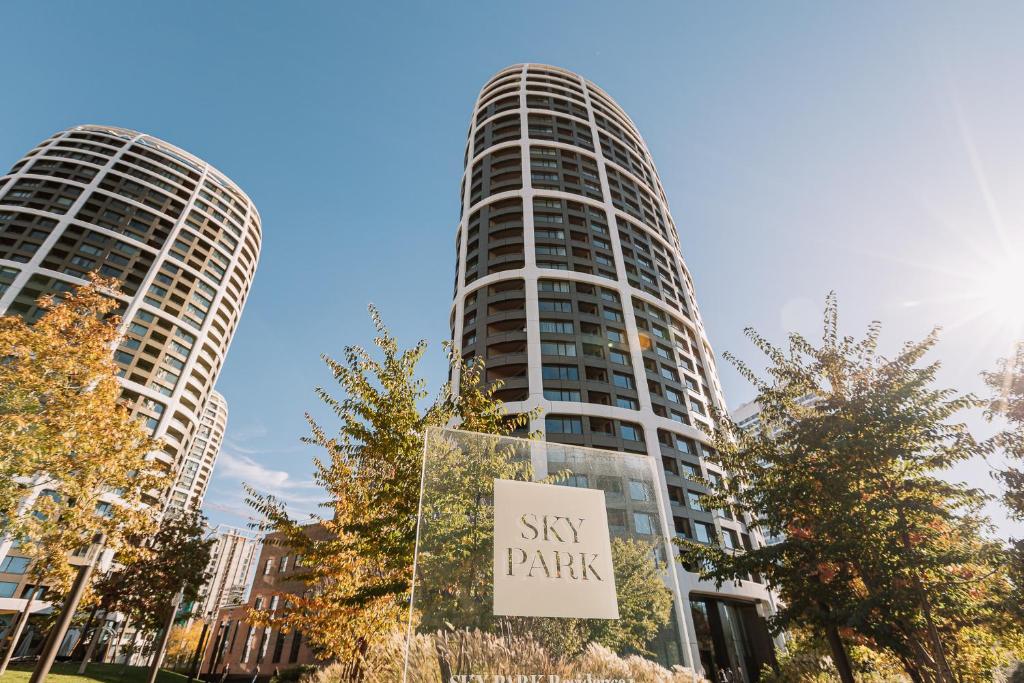 a sign in front of two tall buildings at SKAU Blue Residence in Sky Park 21 floor 2 tower Panoramic View Free Parking in Bratislava