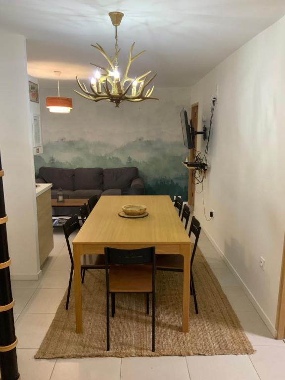 tavolo da pranzo con sedie e lampadario pendente di APPARTEMENT 3 CHAMBRES A LA MONTAGNE a Saint-Michel-de-Maurienne