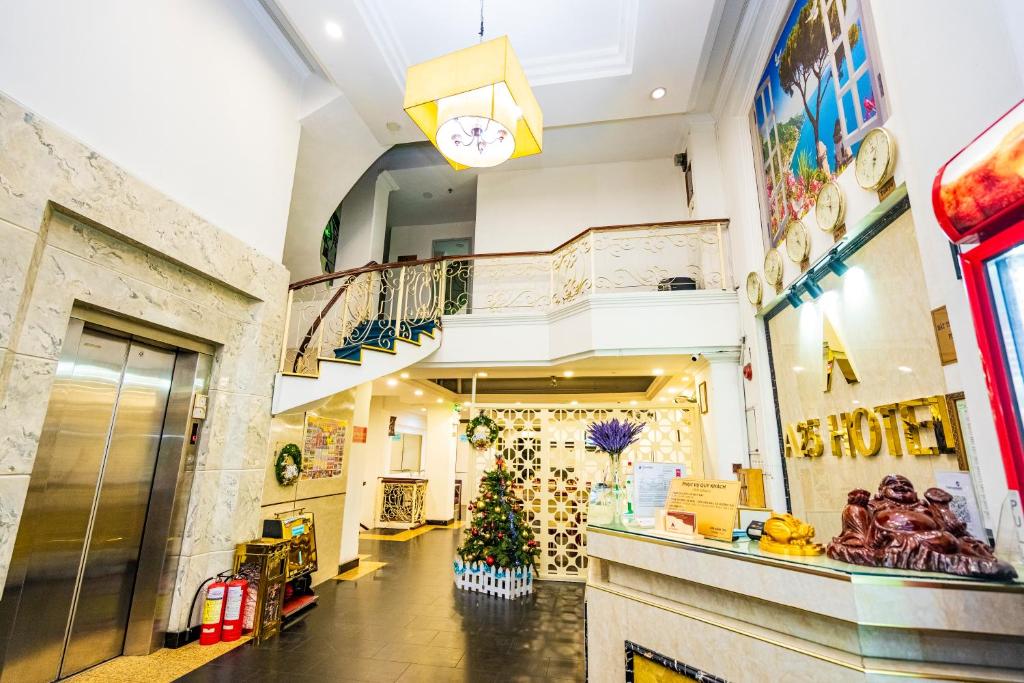 a store hallway with a christmas tree and a clock at A25 Hotel - 251 Hai Bà Trưng HCM in Ho Chi Minh City