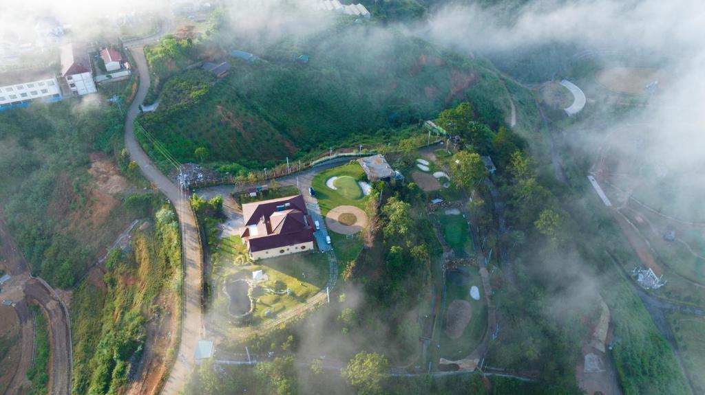 an aerial view of a house on top of a mountain at Four Spring Villas & Golfs Da Lat in Da Lat