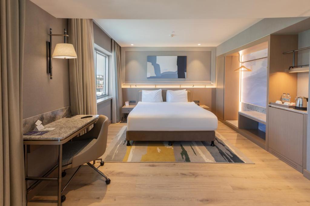 Postel nebo postele na pokoji v ubytování Kolin Hotel Spa & Convention Center