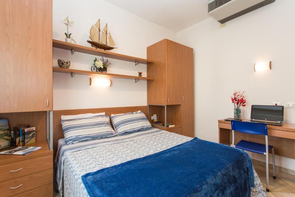 Postel nebo postele na pokoji v ubytování Residence Veliero