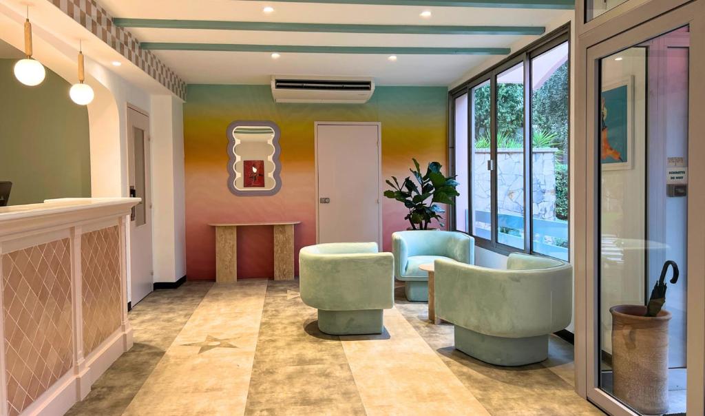 a living room with two chairs and a table at The Hollywood Hotel Cannes in Cannes