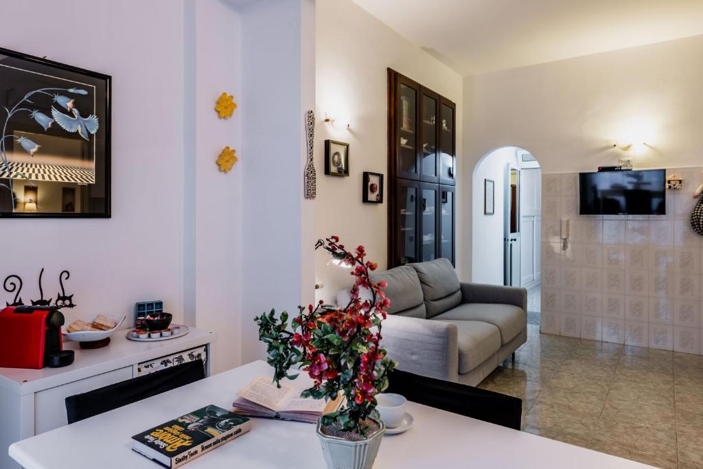 a living room with a couch and a table at Coralie House in Giardini Naxos