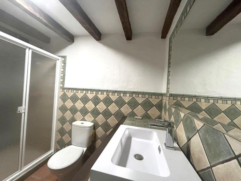a bathroom with a sink and a toilet at Casa Gomez in Gaucín