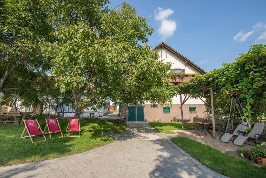 a group of chairs in the yard of a house at Naturparkbauernhof Pöltl in Pöllau