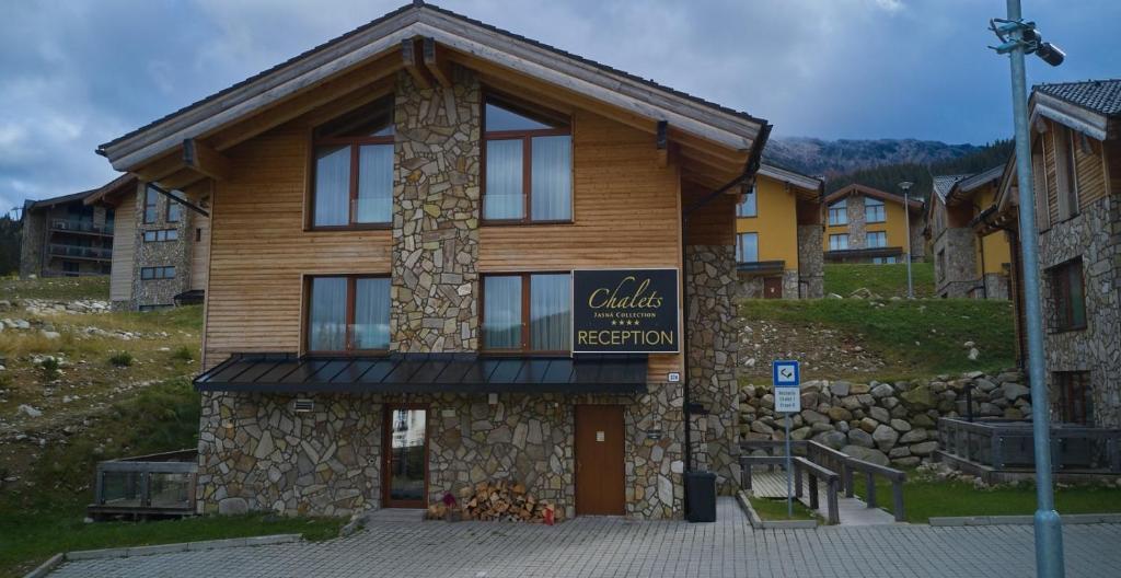 a building with a sign on the front of it at Chalet Jasná Apartment Franco jacuzzi & sauna in Demanovska Dolina