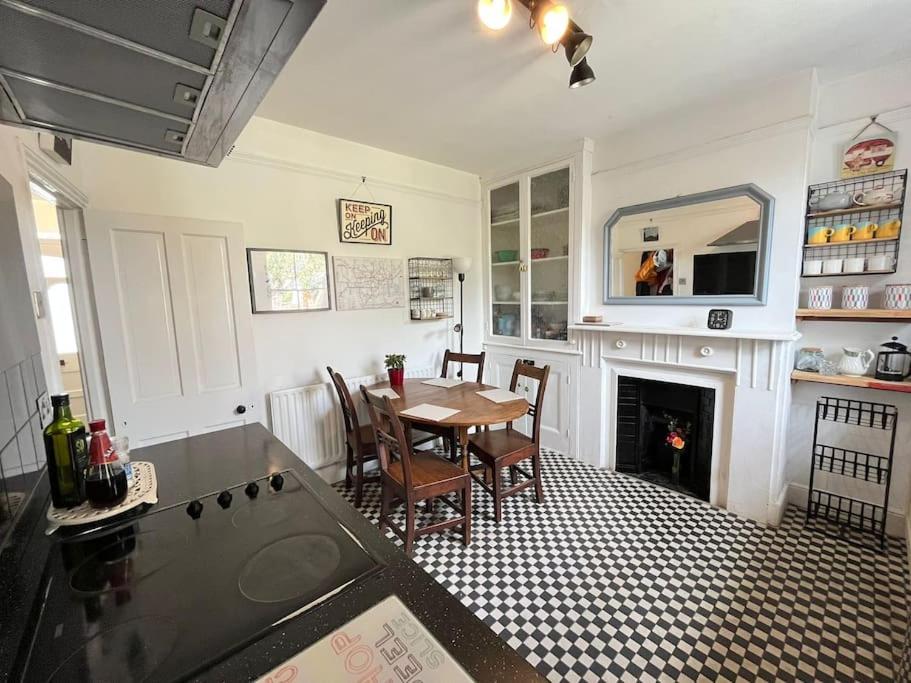 a kitchen with a table and a dining room at 2BR Edwardian House in Greenwich in Abbey Wood