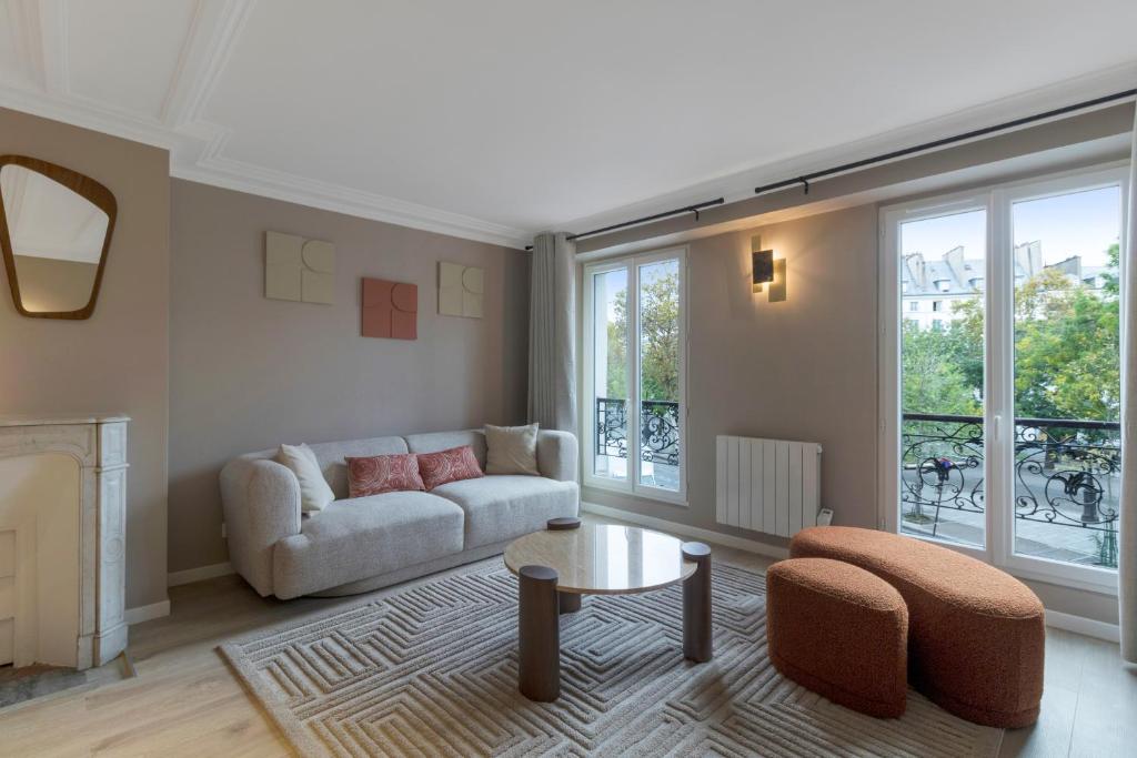 a living room with a couch and a table at AmazingApartment#4Bedrooms#Bastille#PlaceDesVosges in Paris